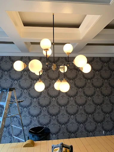 Globe chandelier under a coffered ceiling